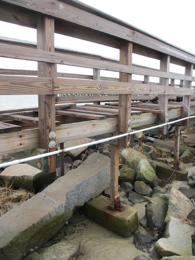This portion of fishing pier built on concrete sleepers laid on the sand was destroyed in the hurricane. The deeper water area secured to pilings was not damaged. (Wave photo)