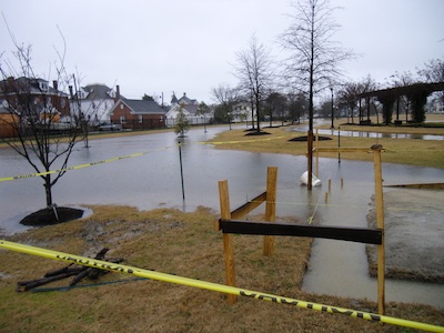 Site of future Central Park bathrooms. Due to flooding conditions, bathroom floor will be elevated to height of wooden crossmember behind yellow tape. (Wave photo)
