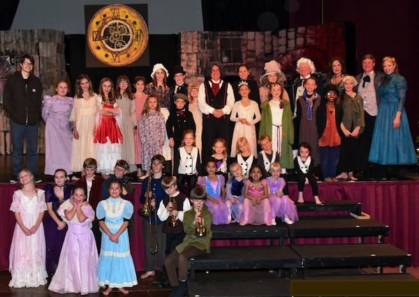 A Christmas Carol cast lit up the Palace Theatre stage. (Photo: Chris Glennon)